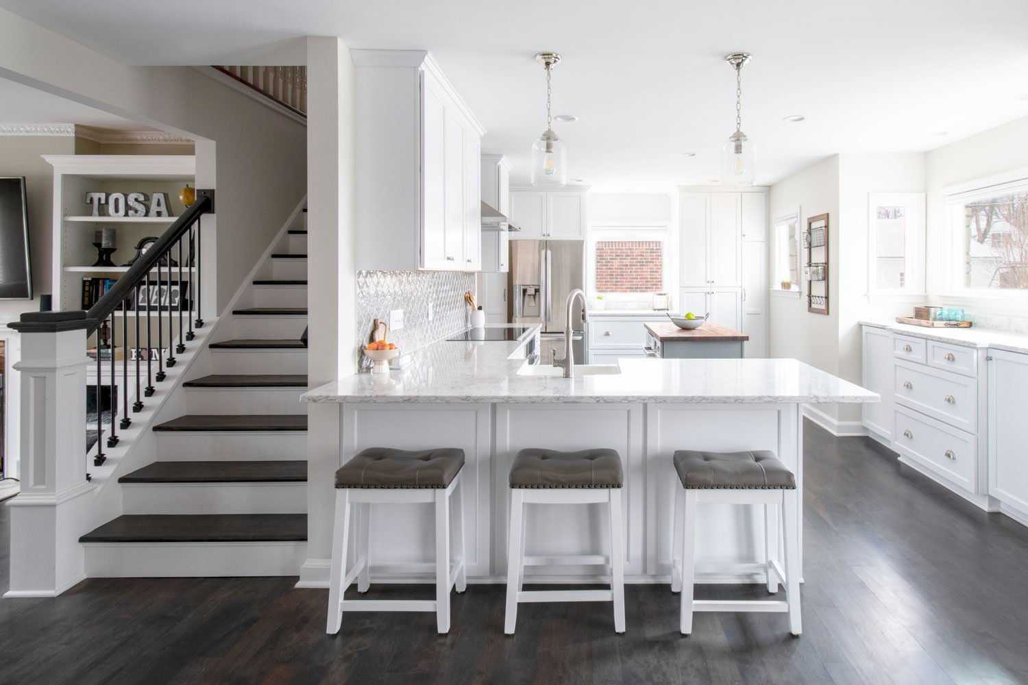 Striking yet simple! We love this Wauwatosa kitchen transformation! The closed off kitchen and staircase is now the center of this home.